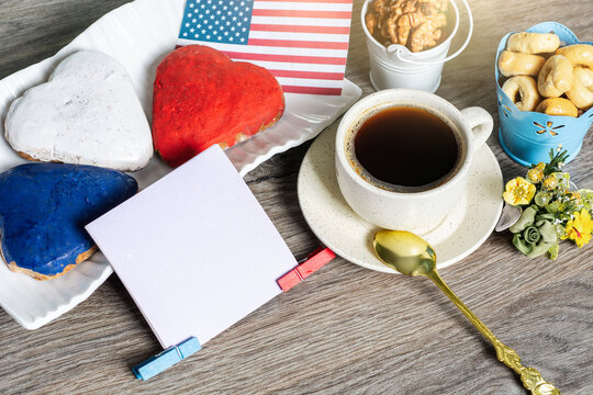 American patriotic Patriotic breakfast with heart shaped cookies, coffee cup and blank note card on wooden background