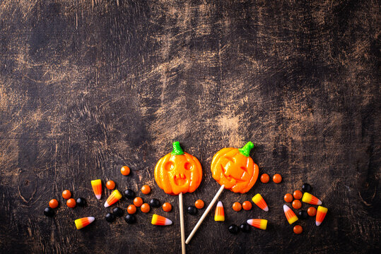 Halloween pumpkin jack-o-lantern candy with different sweets