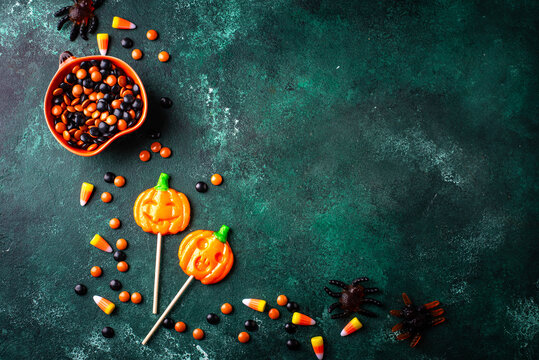 Halloween pumpkin jack-o-lantern candy with different sweets