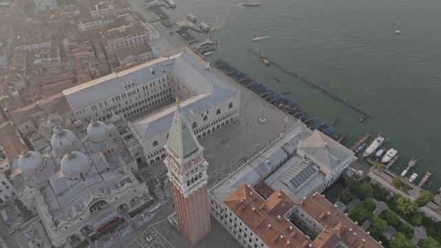 Aerial view of St. Mark's Square, the Campanile, and the Doge's Palace surrounded by historic rooftops and the lagoon in Venice, Veneto, Italy.
