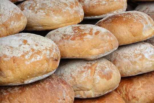 Pile of freshly baked wholemeal breads in the bakery or local farmer market.