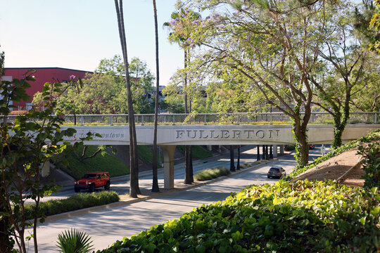 Fullerton, California, USA - Welcome Sign on Downtown Train Overpass Above Harbor Boulevard With Moving Traffic, Railroad Infrastructure and Busy Urban Streets on a Sunny Day