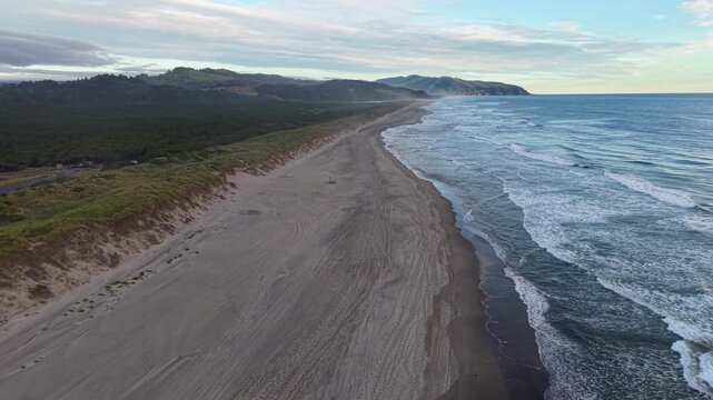 OREGON - 9.2.2026 - Good aerial footage moving up the coastline of Oregon's Pacific City Beach.