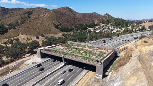 CALIFORNIA - 9.22.2026 - Very good aerial footage starting to circle clockwise around the Wallis Annenberg Wildlife Crossing, still under construction over California's active Highway 101.