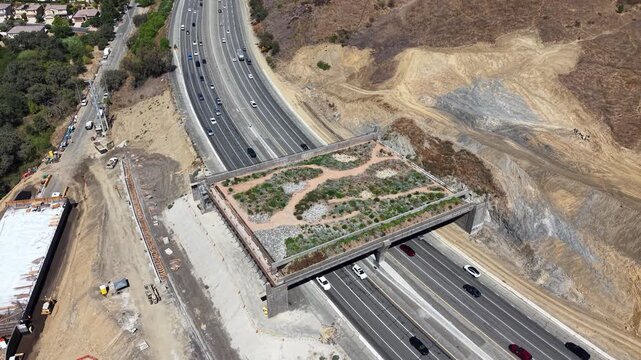 CALIFORNIA - 9.22.2026 - Great aerial footage starting to circle counterclockwise around the Wallis Annenberg Wildlife Crossing, still under construction over California's active Highway 101.