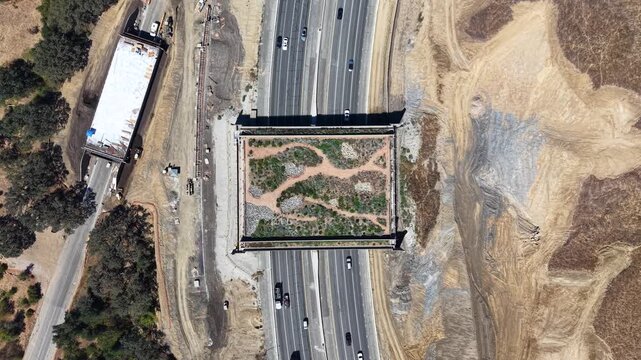CALIFORNIA - 9.22.2026 - Fantastic bird's eye view of the Wallis Annenberg Wildlife Crossing, still under construction, as Highway 101 traffic passes beneath it.