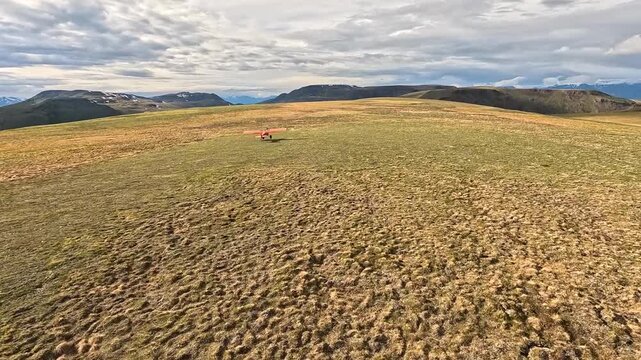ALASKA - 9.3.2026 - Stunning aerial footage following a bush pilot flying over green hills in Alaska.