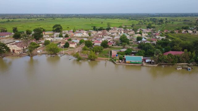 GAMBIA - 12.19.2025 - Great aerial panorama of a garden camp on the banks of the Gambia River.