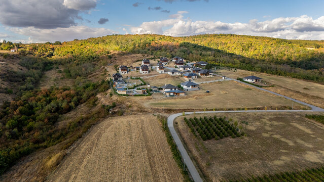 Aerial view of Ruza vetrova resort featuring modern villas nestled in the hilly landscape of Fruska Gora with surrounding forests and vineyards in Mala Remeta, Vojvodina, Serbia.