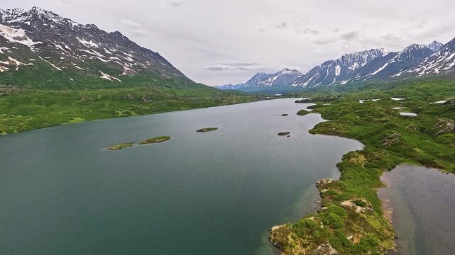 ALASKA - 9.3.2026 - Good aerial footage moving over Tebay River near snowy mountains in Alaska's Wrangell-St. Elias National Park and Preserve.