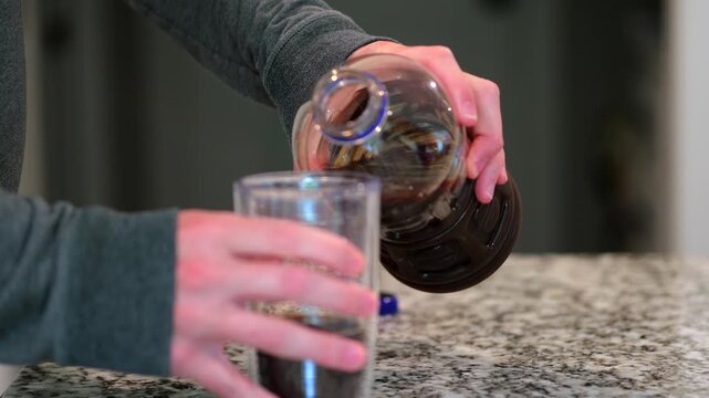 Middle aged man drinking prune juice to aide digestive health naturally - gut health constipation relief remedy aging gracefully preventive wellness
