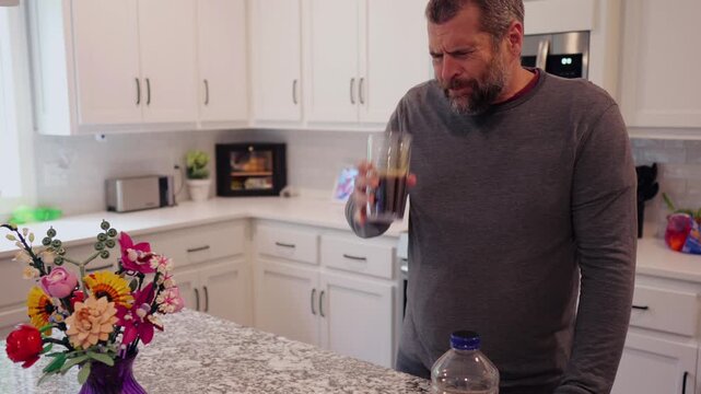 Middle aged man drinking prune juice to aide digestive health naturally - gut health constipation relief remedy aging gracefully preventive wellness