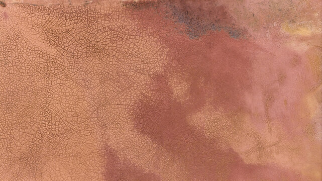 Aerial view of salt production patterns with cracked earth and vibrant textures in Kalbarri, Western Australia, Australia.
