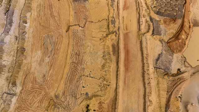 Aerial view of industrial mining patterns and earth textures with intricate tracks and sand formations at a mining site in Kalbarri, Western Australia, Australia.