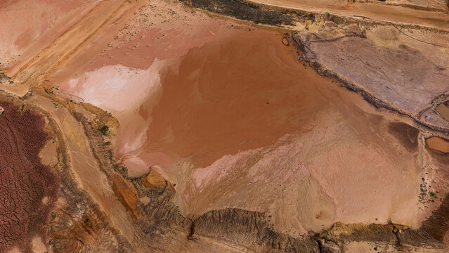 Aerial view of colorful industrial salt mine patterns and mineral deposits with sand and earth textures in the landscape of Useless Loop, Kalbarri, Western Australia, Australia.