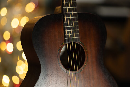 coustic Guitar Close Up with Warm Christmas Lights Bokeh
