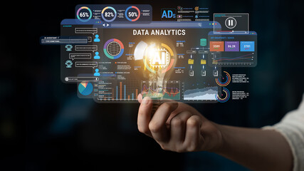 Obraz premium Innovative Data Analytics Concept with Futuristic Interfaces and Light Bulb Representing AI Technology and Insights in Modern Business Environment Fluxor.