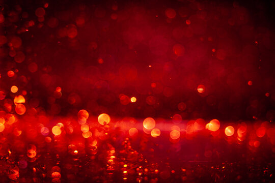 Bright red light reflections create a vibrant background