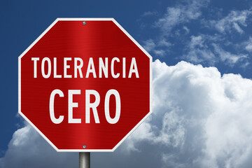 Red Zero Tolerance sign Tolerancia Cero in Spanish with sky © Karen Roach