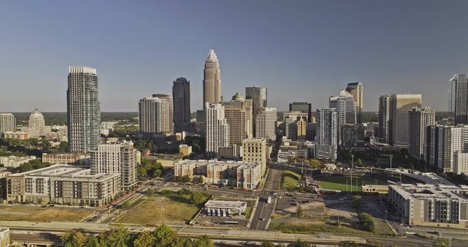 Charlotte North Carolina Aerial v142 low flyover Fourth Ward around the city center capturing the vibrant downtown cityscape against a cloudless blue sky - Shot with 5k Camera - Oct 1st 2023
