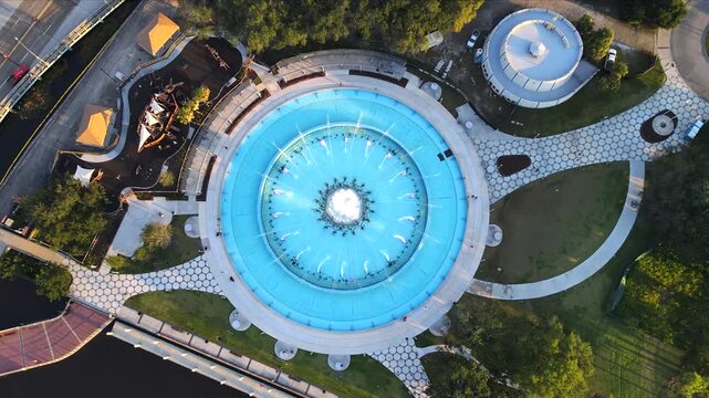  Drone holds above Friendship Fountain while showing the turquoise basin and water jets in Jacksonville.
