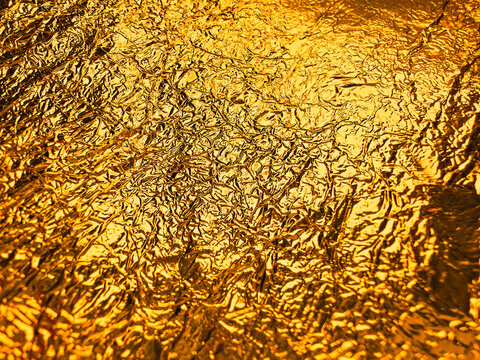 Gold foil texture. Shiny gold leaf, rough foil texture for background and art design, Horizontal photo, golden foil with folds premium abstract with gold foil texture background. Luxury for invitation