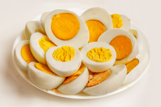 Hard-boiled eggs sliced on plate ready for eating