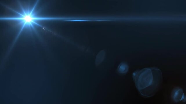 Lens flare bursts with warm orange and cool blue light in dark atmospheric background during cinematic slow motion