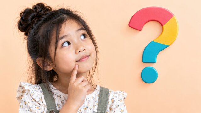 Thoughtful Young Girl Looking at Colorful Question Mark on Pastel Background