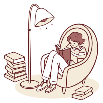 Young person reading book in comfortable armchair by floor lamp with book