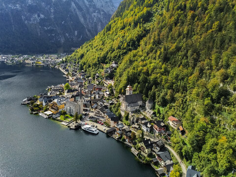 Aerial view of Hallstatt, a historic lakeside village with traditional alpine architecture and the iconic Evangelical Church nestled between mountains in Hallstatt, Upper Austria, Austria.