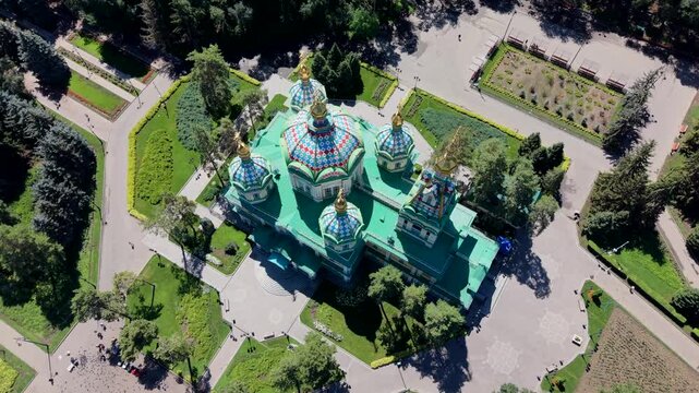 Aerial view of Zenkov Cathedral surrounded by lush greenery and park pathways in Almaty, Almaty Region, Kazakhstan.