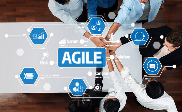 This image depicts a team engaged in collaborative Agile practices, emphasizing hands-on cooperation and innovative problem-solving in a modern workspace environment. Amity