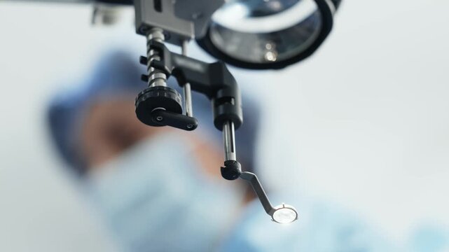 Ophthalmic microscope optics with surgical illumination in a modern operating room.