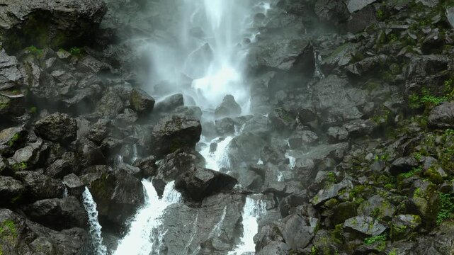 Powerful Mountain Waterfall Rushing Down Dark Rocks Water Mist Hydro Power Concept