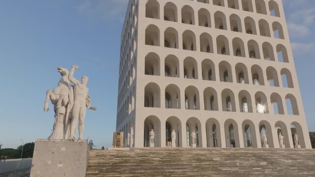 Aerial view of the iconic Palazzo della Civilta Italiana featuring its distinctive arched facade and surrounding statues in Roma, Lazio, Italy.