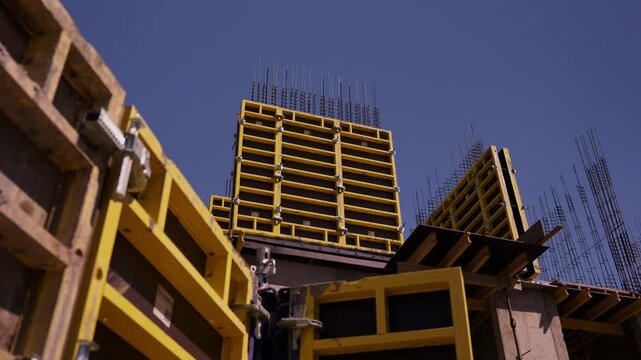 Yellow wall formwork and reinforcement at concrete building construction