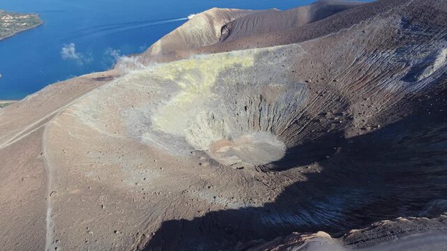 Aerial view of the volcanic crater of Vulcano with sulfur deposits and rugged terrain in Lipari, Sicily, Italy.