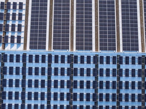 Aerial view of solar panels installed on a large industrial factory roof in Kilsyth South, Melbourne, VIC, Australia.