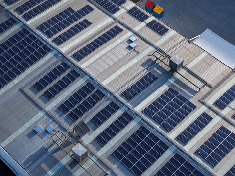 Aerial view of solar panels installed on the roof of a factory in Kilsyth South, Melbourne, VIC, Australia.