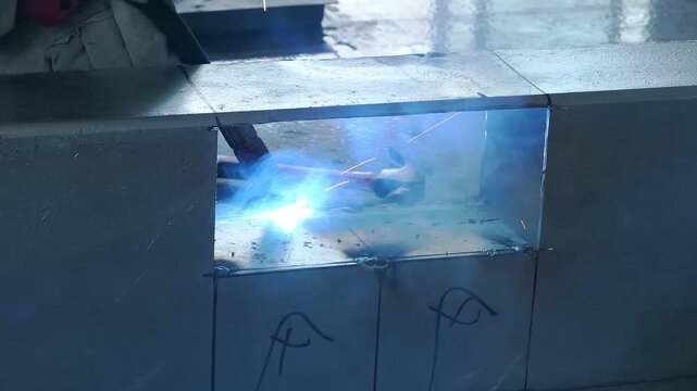 Welding torch melting metal seam on thick steel workpiece