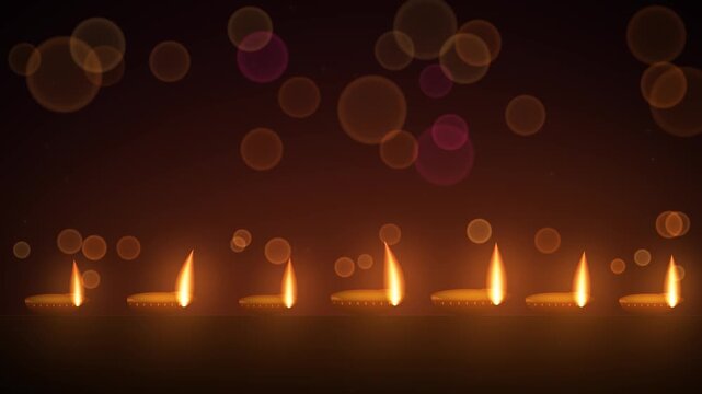 Row of clay diya oil lamps with softly flickering flames on a ledge, warm bokeh lights and copy space above for Diwali