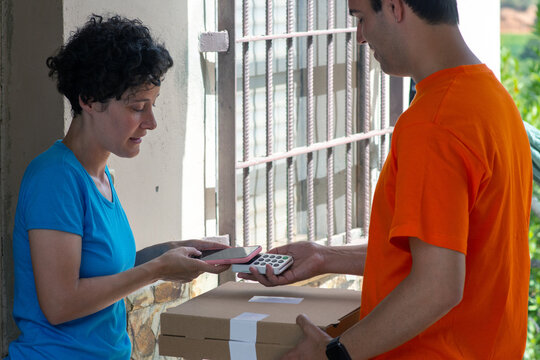 Customer paying contactless for pizza delivery service