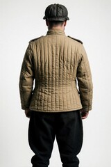 Obraz premium Rear view of man in World War II Russian tank crew uniform. Beige quilted jacket, black pants, dark cap. Historic military style portrait for archival, reenactment themes. posed against plain white