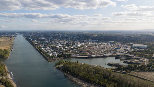 Aerial view of the BASF chemical plant complex situated along the Rhine river with industrial infrastructure, storage tanks, and warehouses in Ludwigshafen am Rhein, Rheinland-Pfalz, Germany.