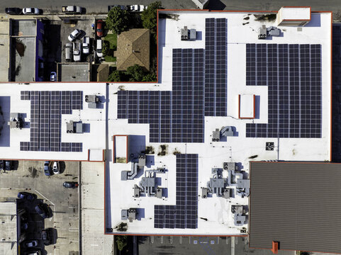 Aerial view of solar panel layout on the rooftop of a commercial business building in Long Beach, California, United States.