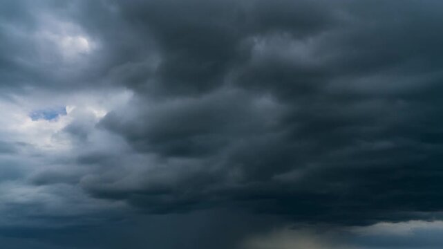 Dense menacing storm clouds moving slowly across a dramatic dark sky