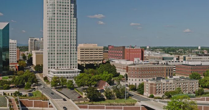 Winston-Salem North Carolina Aerial v5 low tracking flyover across downtown office buildings and the surrounding cityscape - Shot with 8k Camera - Oct 1st 2023