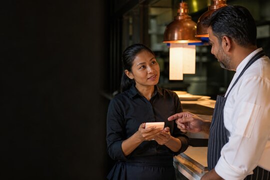 Restaurant allergen training server and chef practicing a repeat-back confirmation