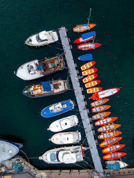 Aerial view of the Old port of Jaffa with various fishing boats and pleasure craft moored along the pier in Tel Aviv-Yafo, Tel Aviv District, Israel.
